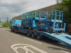 Scissor lifts being transported